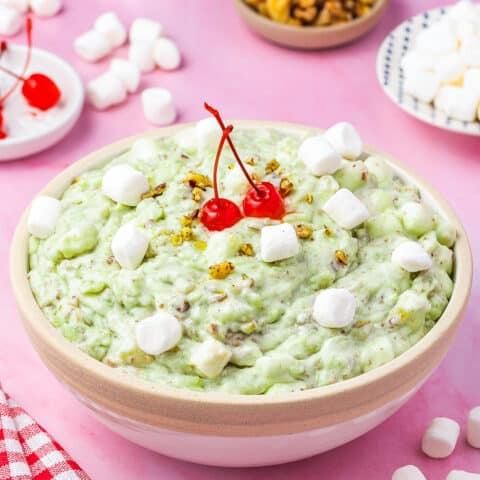 watergate salad in a bowl topped with cherries and marshmallows