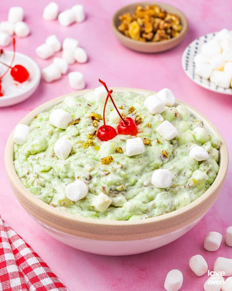 watergate salad in a bowl topped with cherries and marshmallows