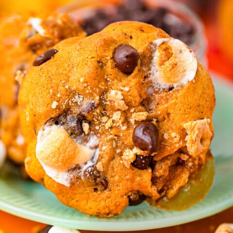 a pumpkin s'mores cookie on a green plate