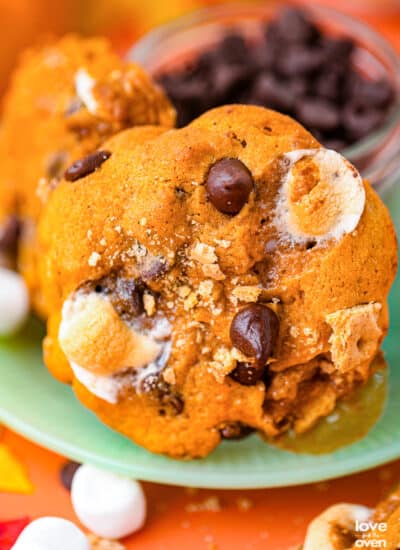 a pumpkin s'mores cookie on a green plate