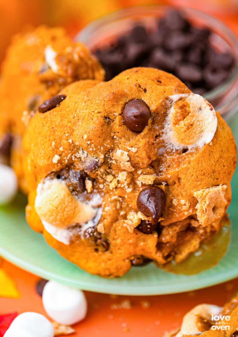 a pumpkin s'mores cookie on a green plate