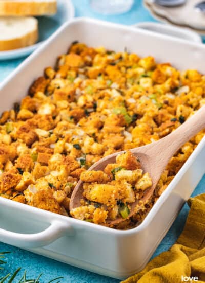 A pan of cornbread stuffing on a blue background