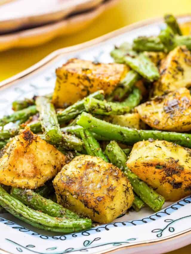 A blue and white dish holding potatoes and green beans