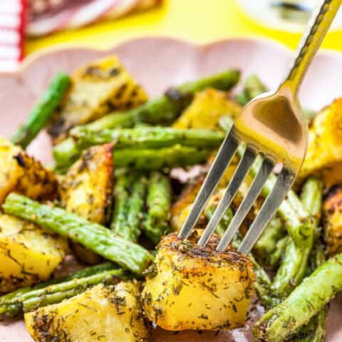 a plate of green beans and poatoes