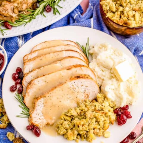Turkey, mashed potatoes and stuffing on a plate.