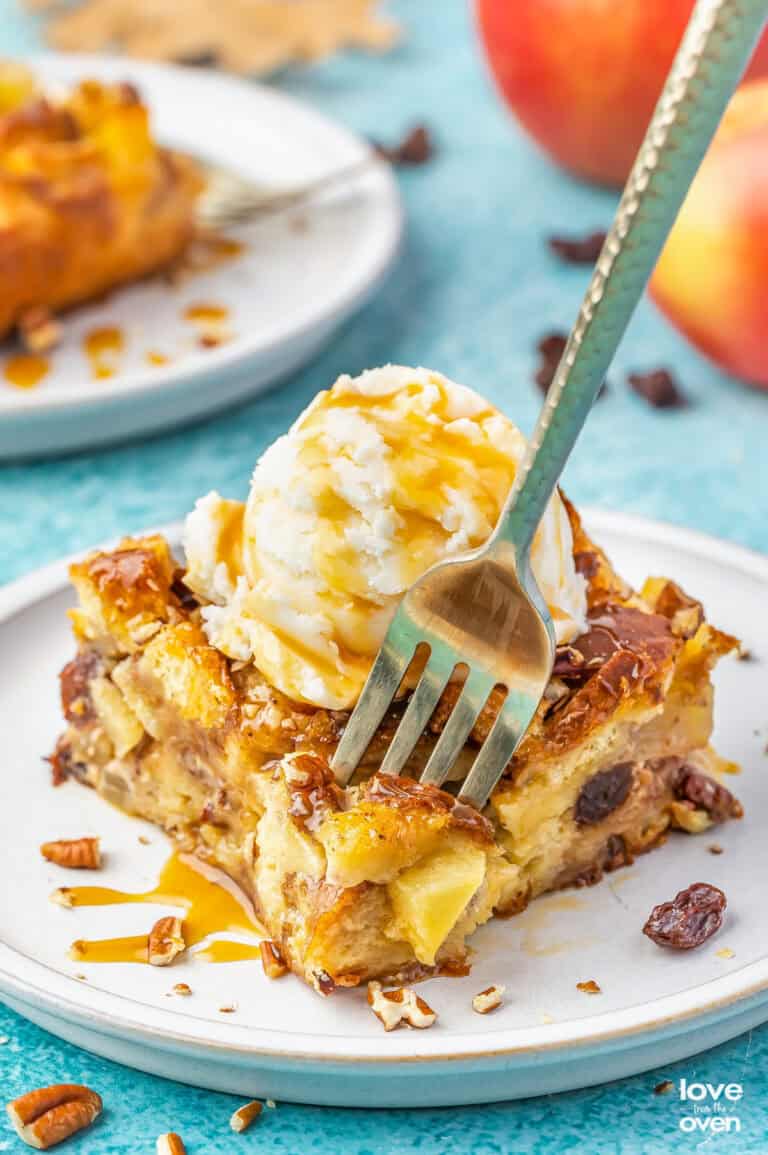 A fork grabbing a bite of apple bread pudding