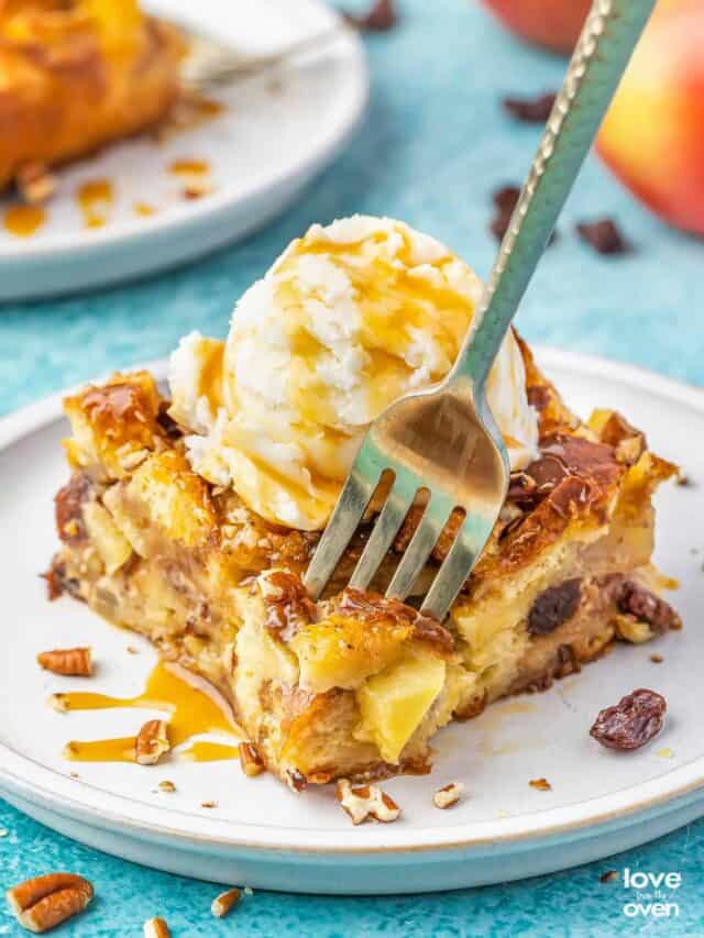 A fork grabbing a bite of apple bread pudding