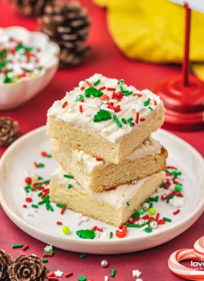 A stack of christmas sugar cookie bars on a plate