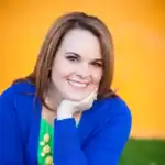 Christi, author of Love From The Oven, wearing a blue sweater and smiling.