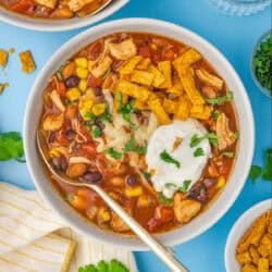 A bowl of seven can taco soup with toppings.