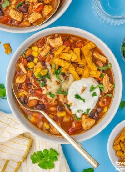 A bowl of seven can taco soup with toppings.
