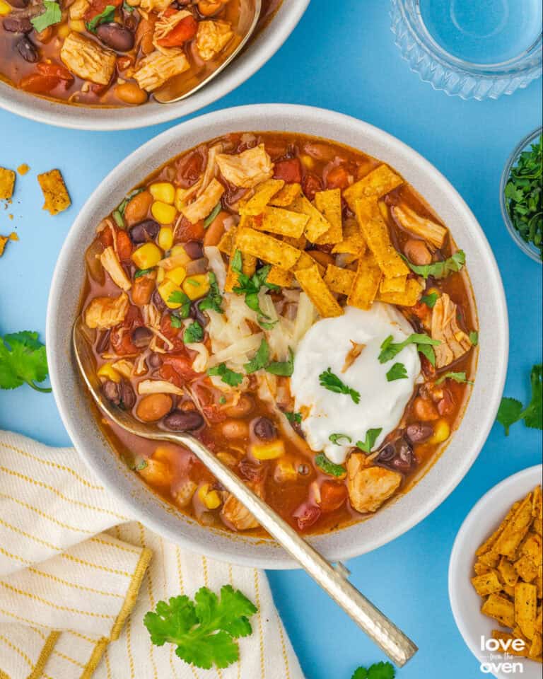 A bowl of seven can taco soup with toppings.