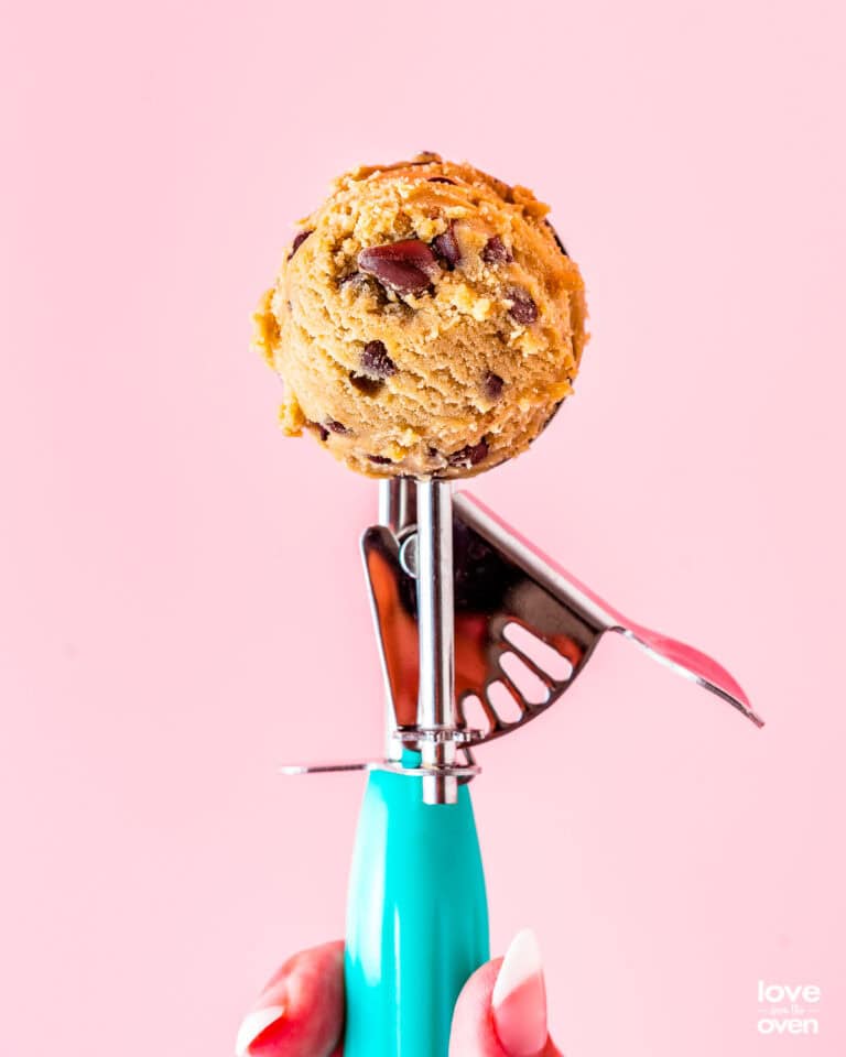 A cookie scoop full of cookie dough
