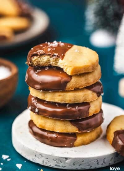 A stack of shortbread cookies that have been dipped in chocolate.