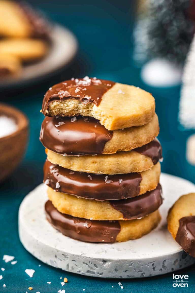 A stack of shortbread cookies that have been dipped in chocolate.