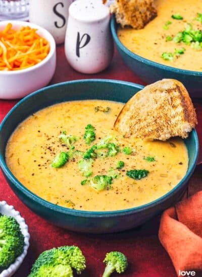 A bowl of copycat Panera Broccoli Cheddar Soup with a piece of bread in it