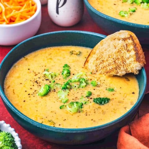 A bowl of copycat Panera Broccoli Cheddar Soup with a piece of bread in it