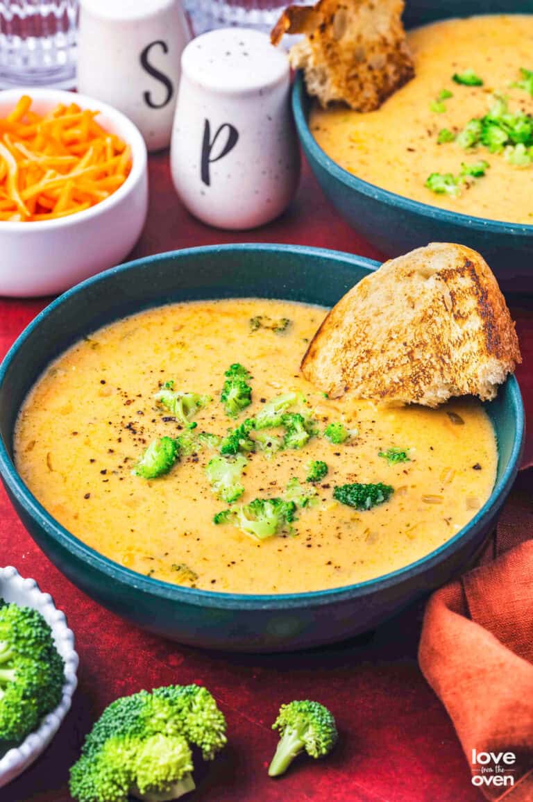 A bowl of copycat Panera Bread Broccoli Cheddar Soup recipe with a piece of bread in it