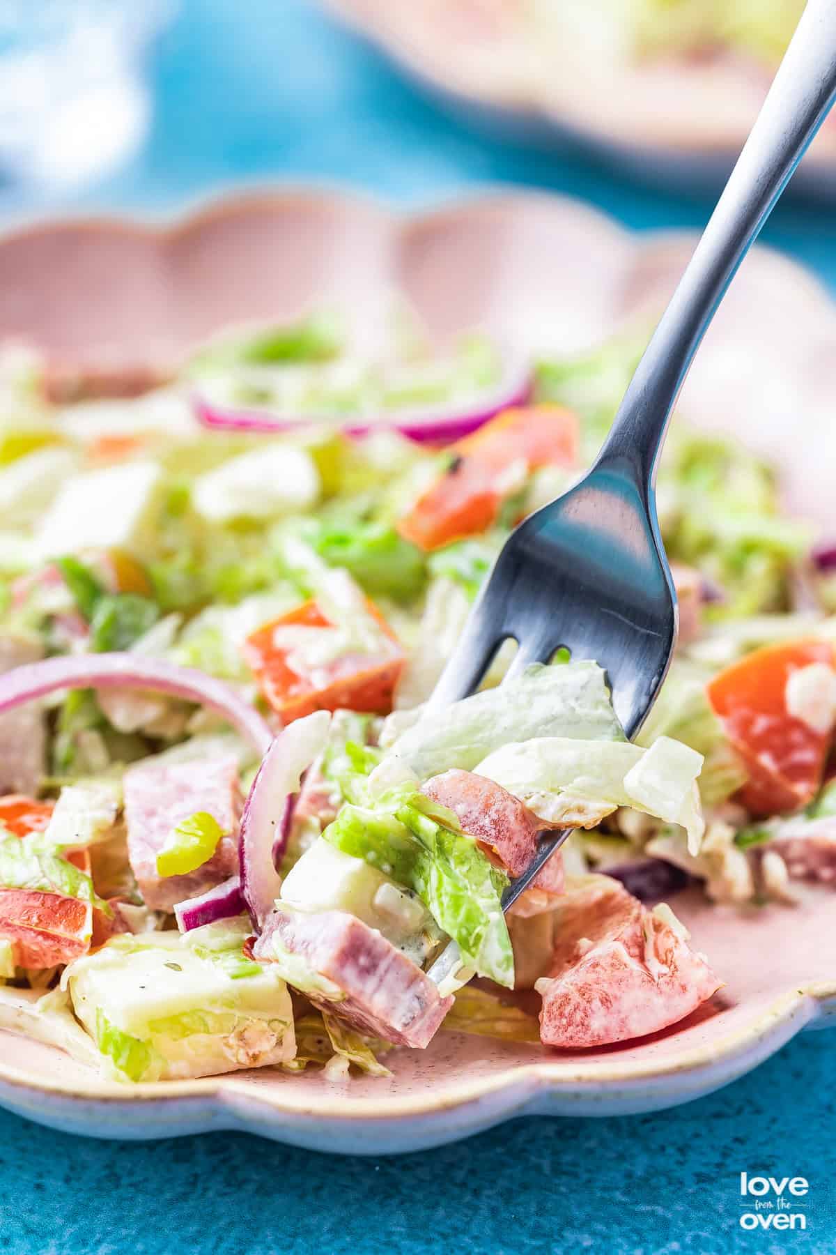 a fork holding a scoop of Grinder Salad