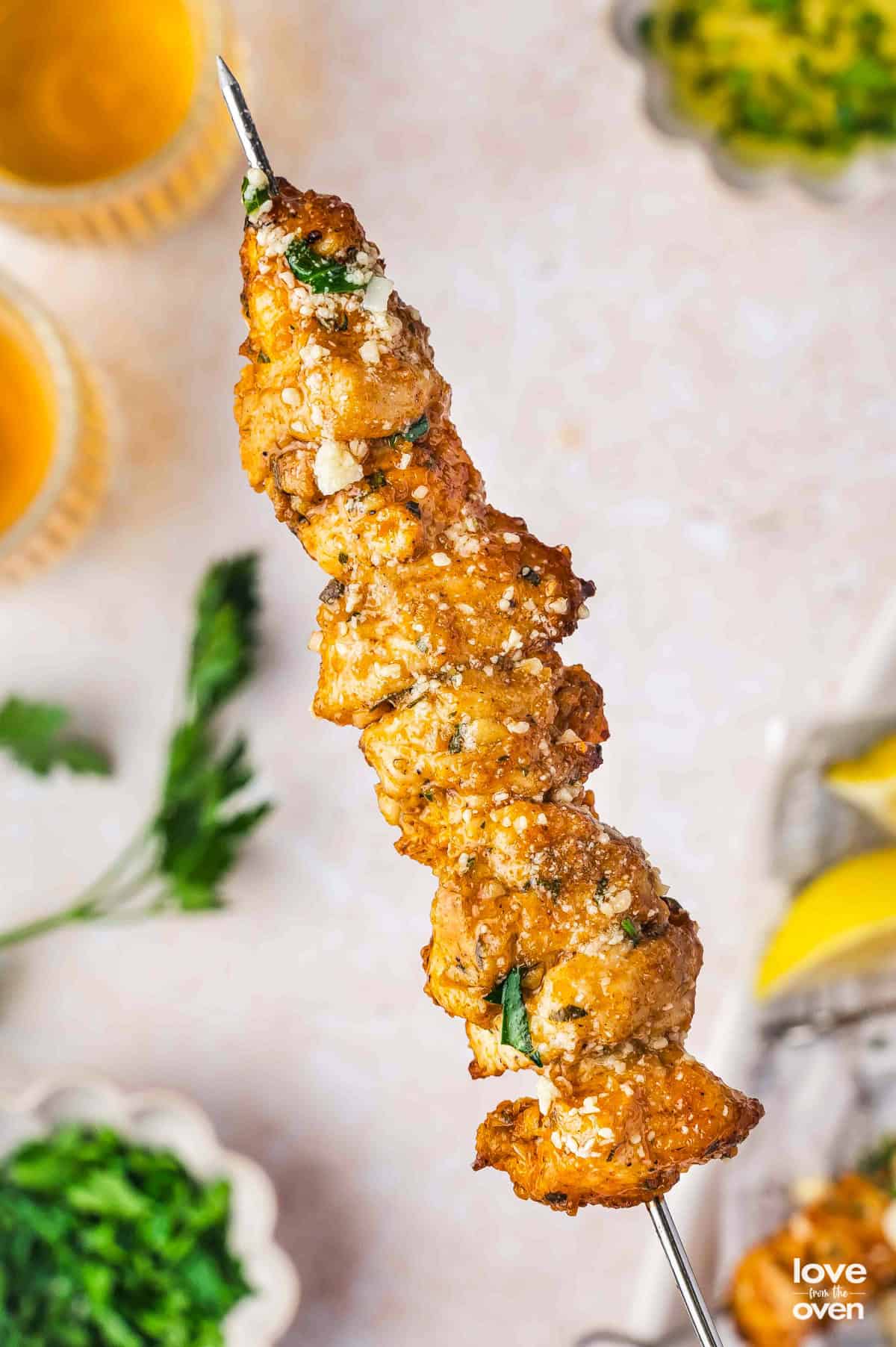A skewer with garlic parmesan chicken on it