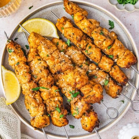 A plate of chicken skewers