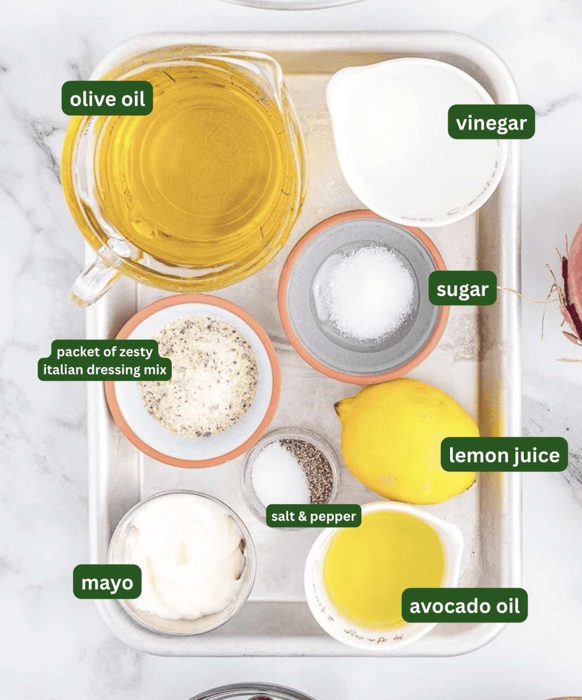 The ingredients to make Olive Garden dressing all sitting on a tray 