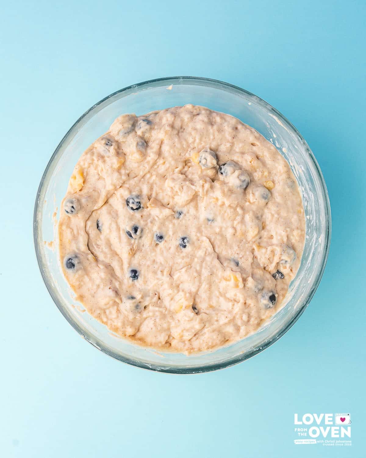 Banana bread batter with blueberries in it in a bowl
