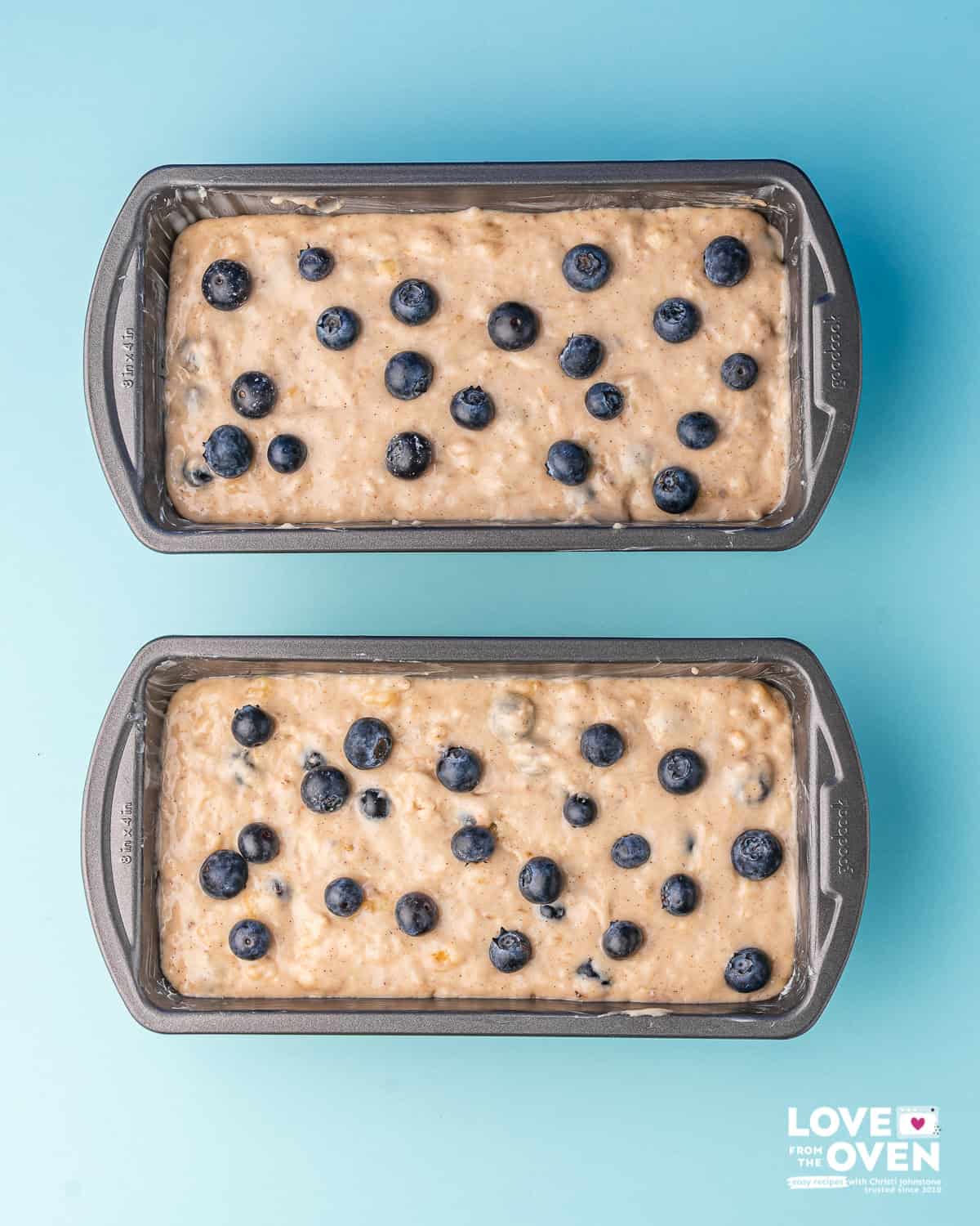 Banana Blueberry bread batter in two loaf pans before being cooked.