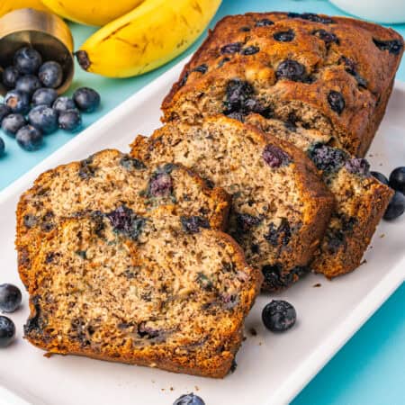 a loaf of blueberry banana bread cut into slices