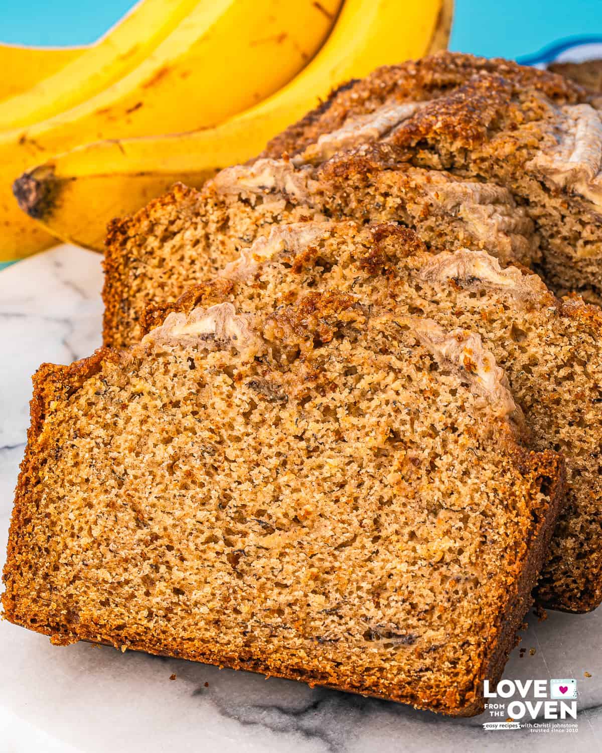 slices of brown butter banana bread lined up on a plate