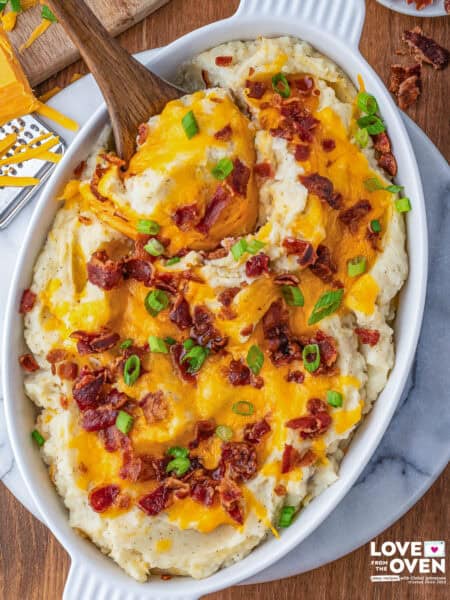 A dish full of loaded mashed potatoes
