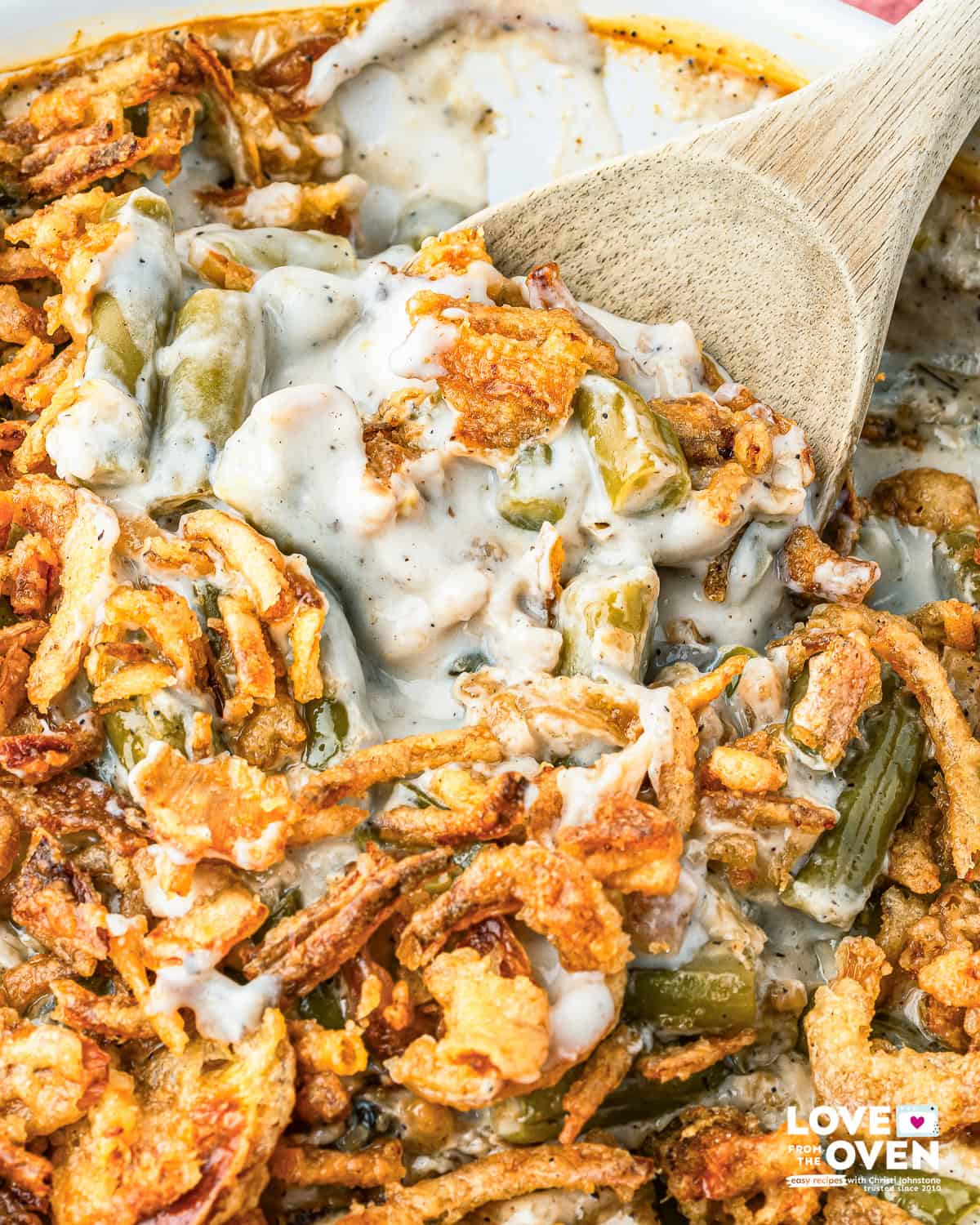 a spoon holding a serving of Campbell's Green Bean Casserole